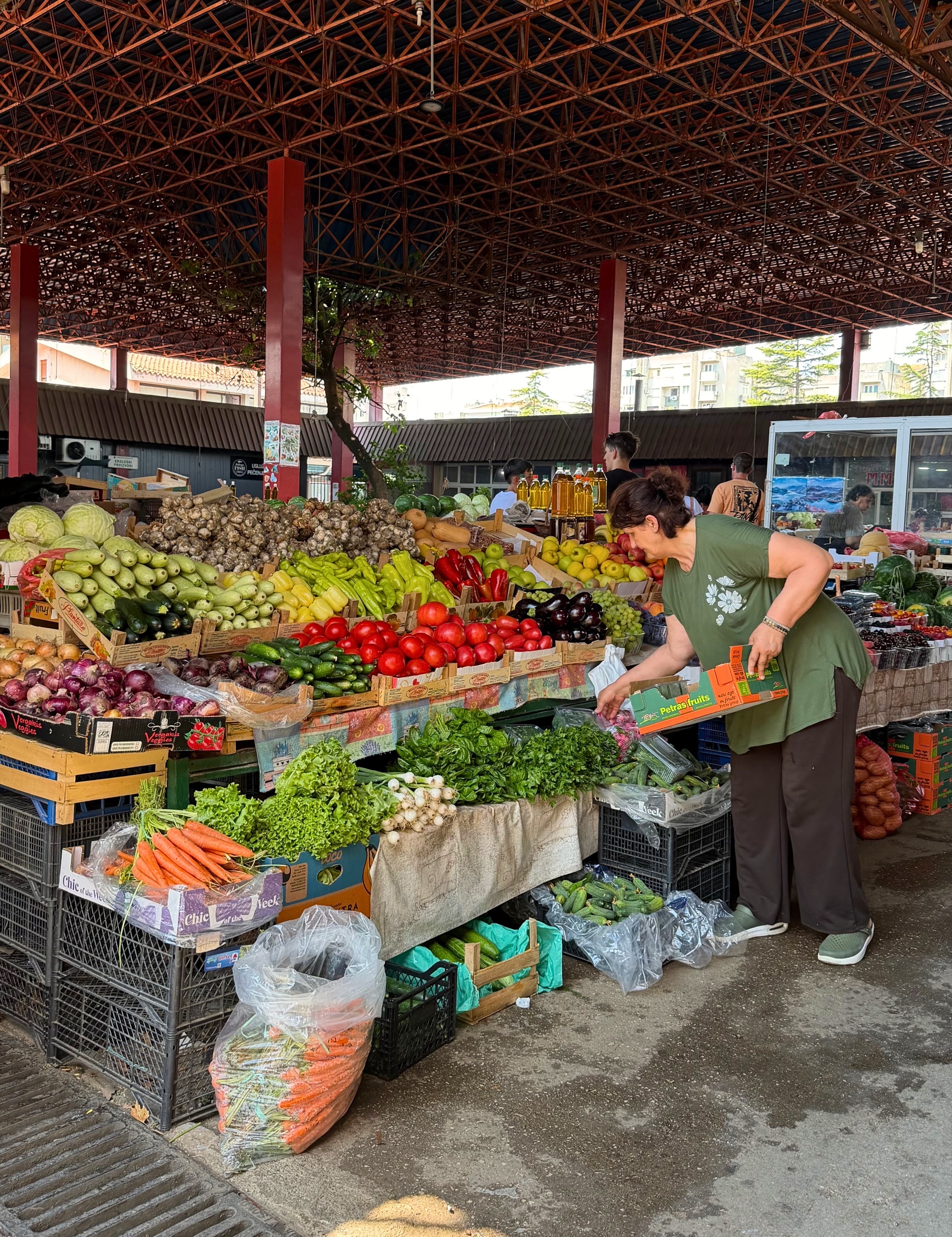Bar farmers market with produce stalls and shoppers