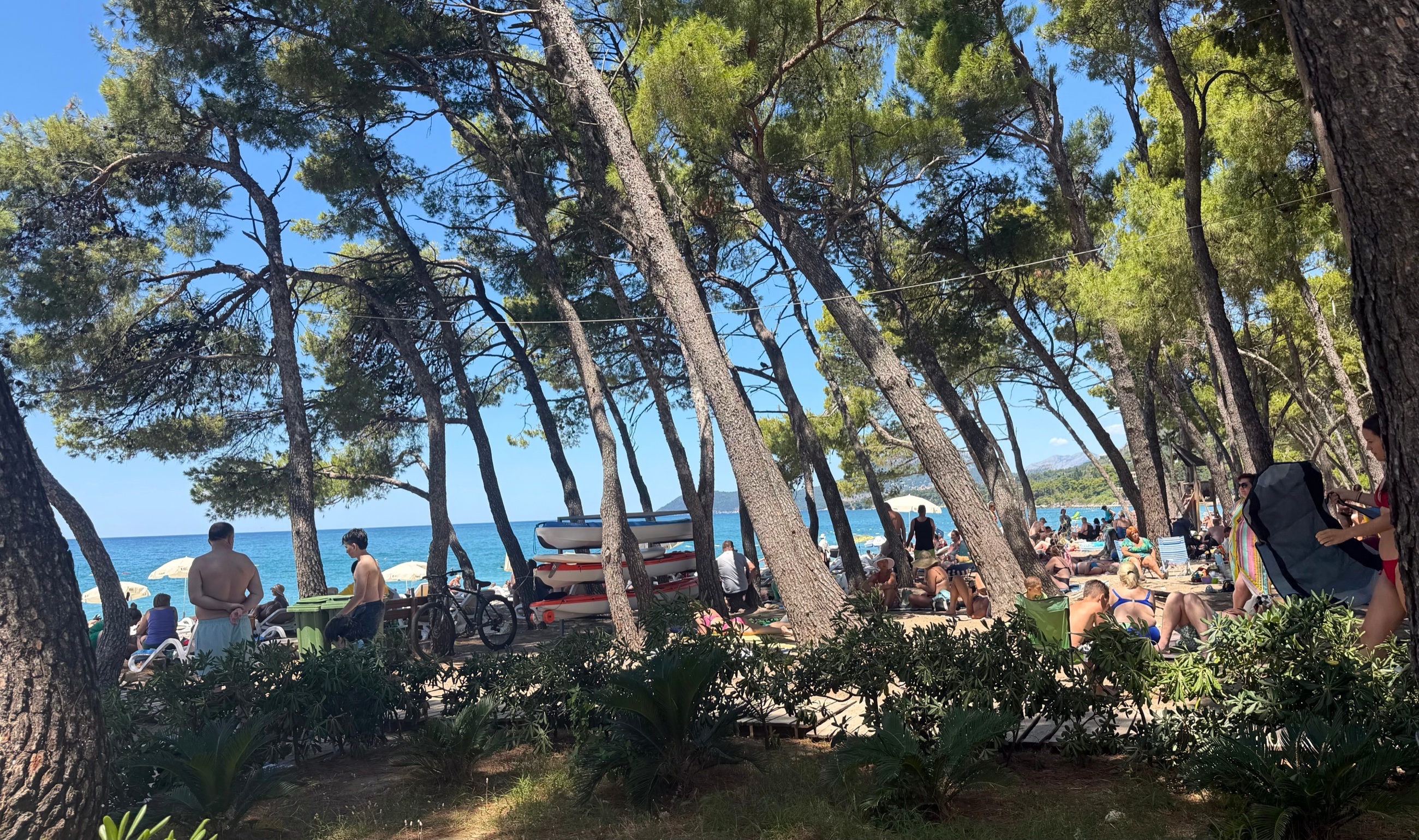 Beach life in Bar with shade, towels, umbrellas, and summer crowds