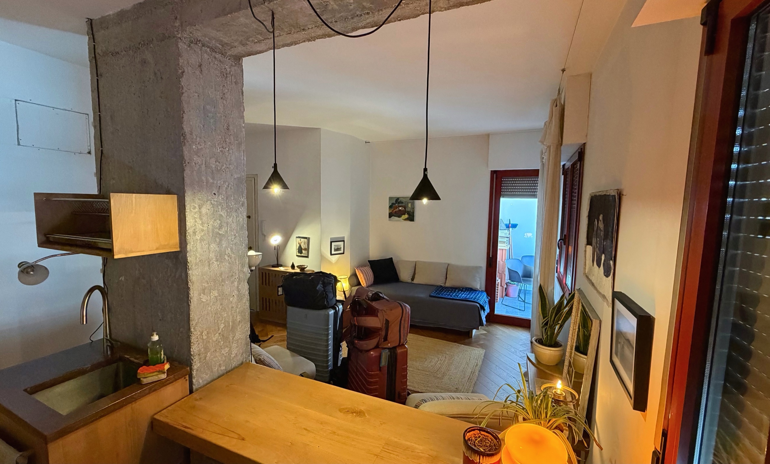 A Tirana apartment with luggage stacked in the living room shortly after arrival.
