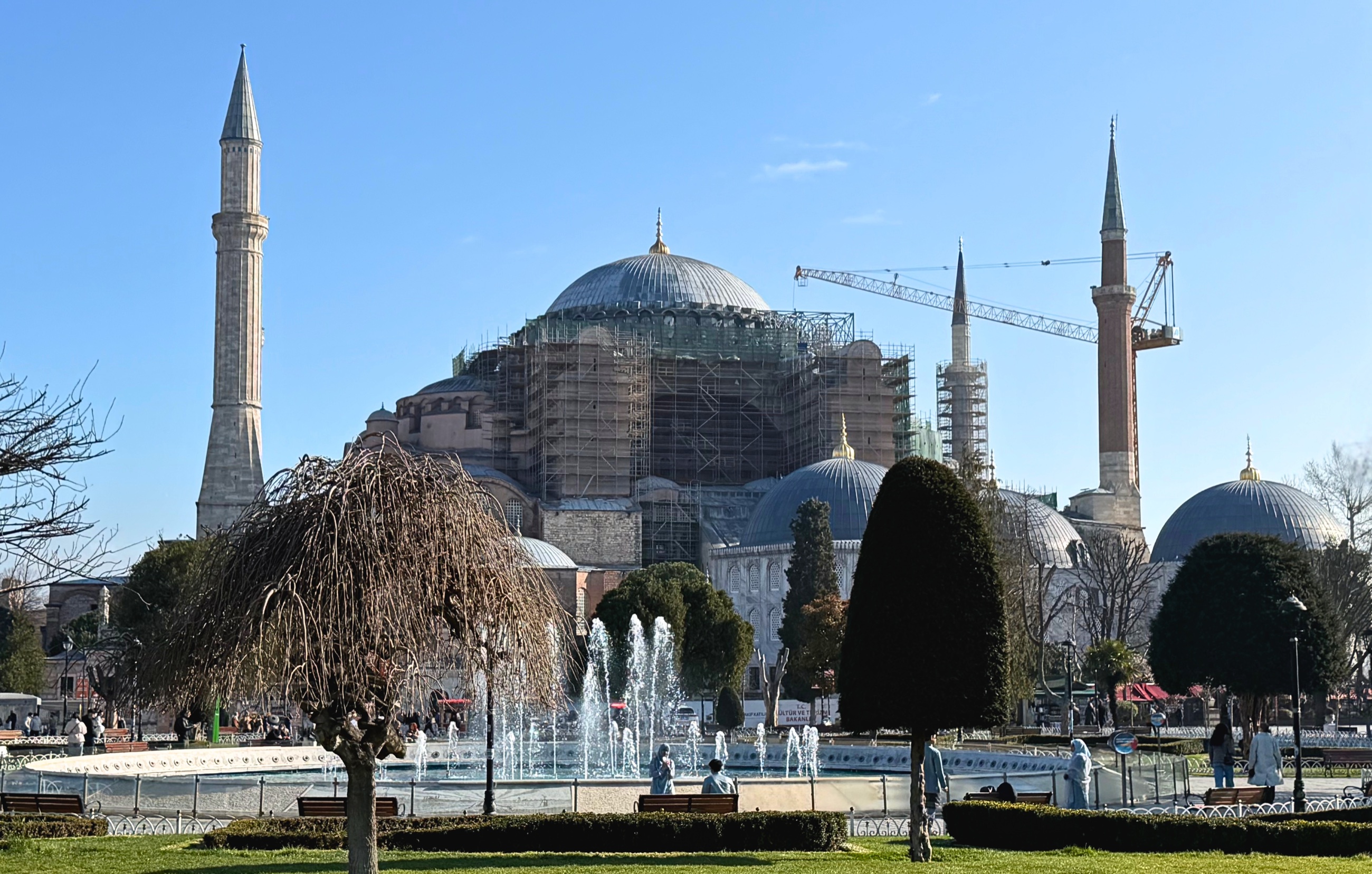 Hagia Sophia under restoration with scaffolding and cranes visible above Sultanahmet Square.