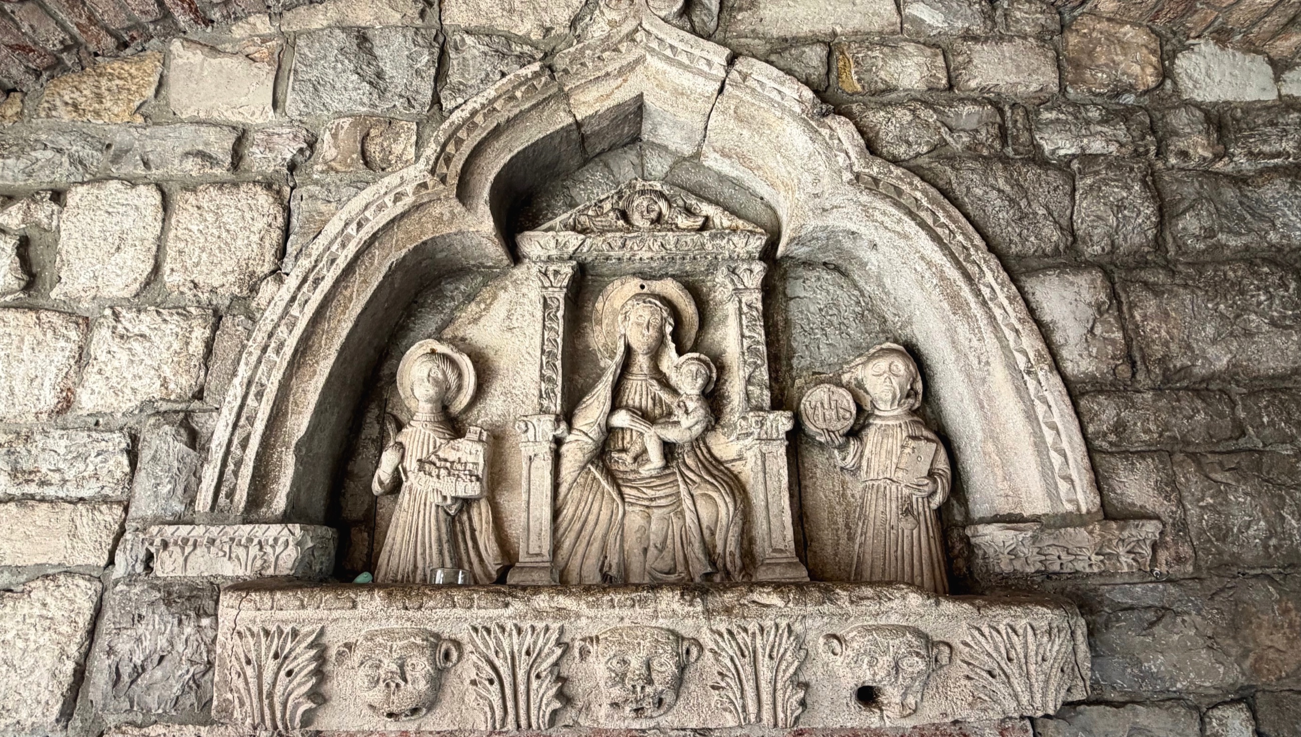 A carved stone relief set inside Kotor's Sea Gate passage.