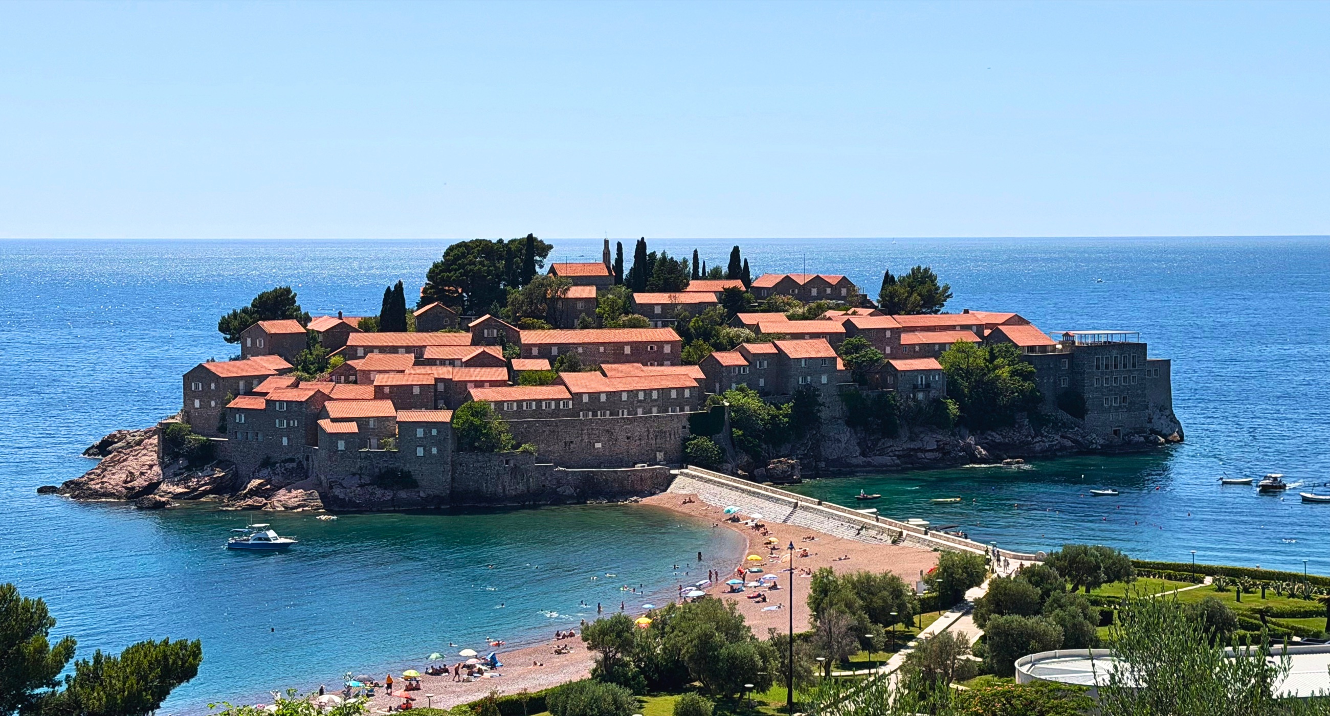 Sveti Stefan from above, with the fortified island, narrow sandbar, and Adriatic beyond.
