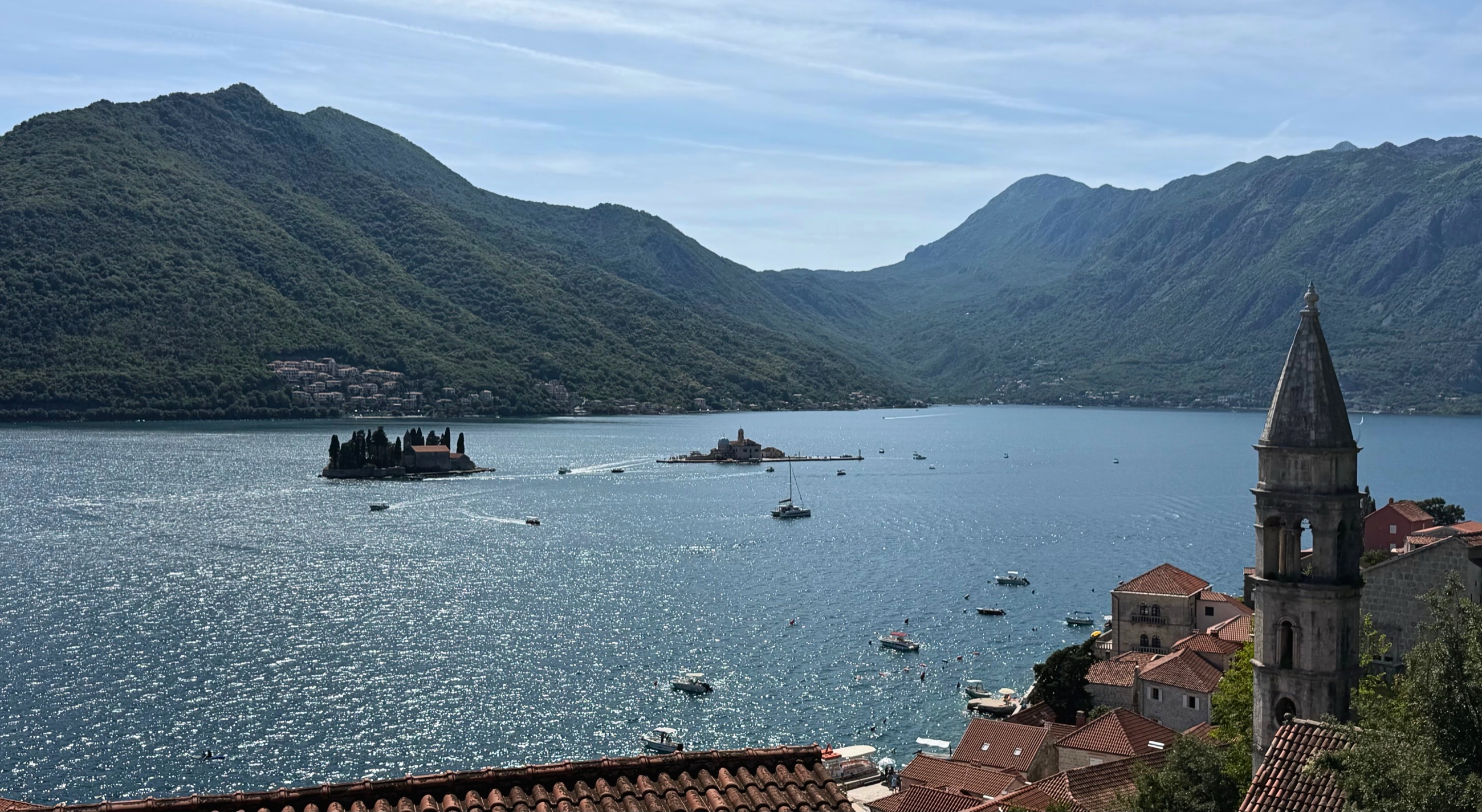 Perast from above, with the two island churches set against the mountain wall of the bay.