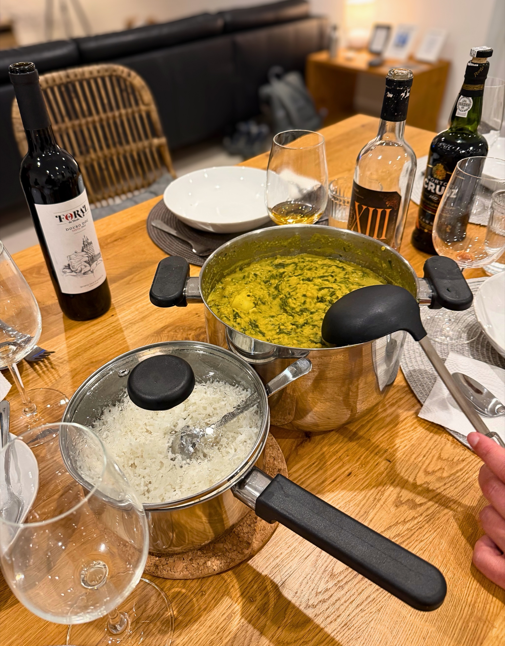 A shared dinner table with dhal, rice, wine, and port at home in Lagos.