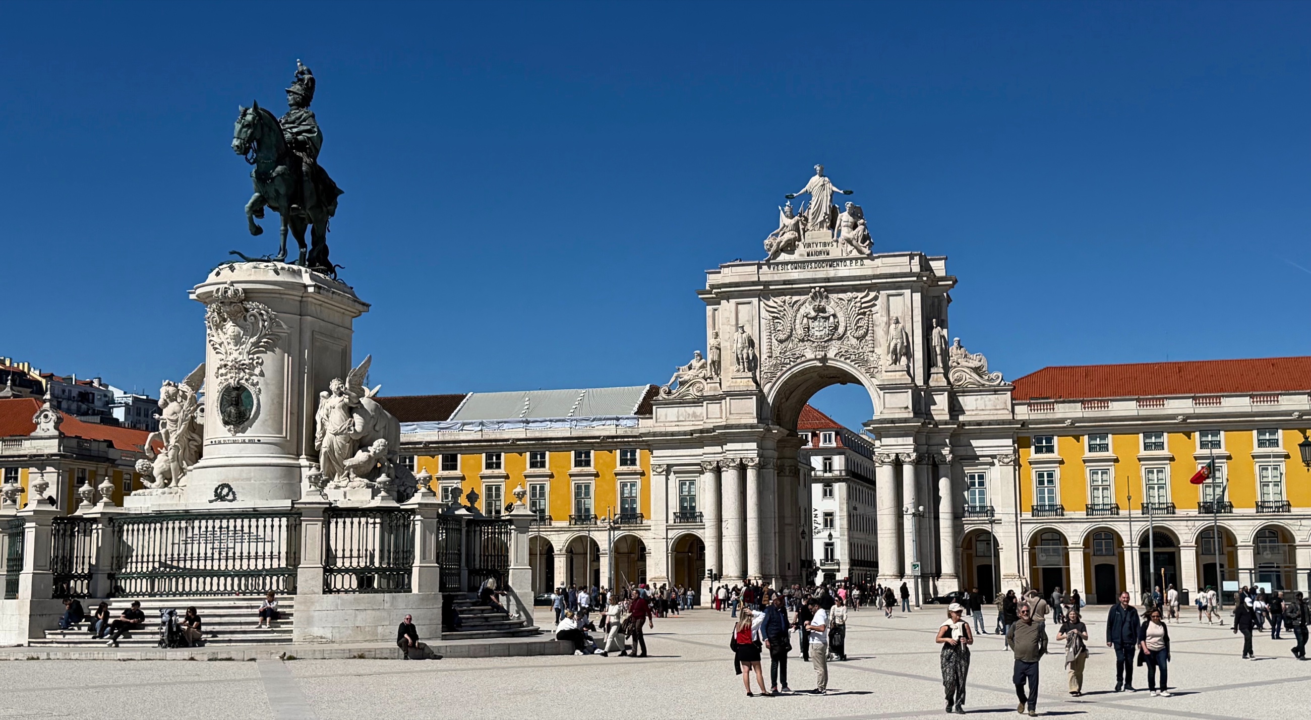 Praça do Comércio in Lisbon with its large open square, arcades, and the equestrian statue at the center.