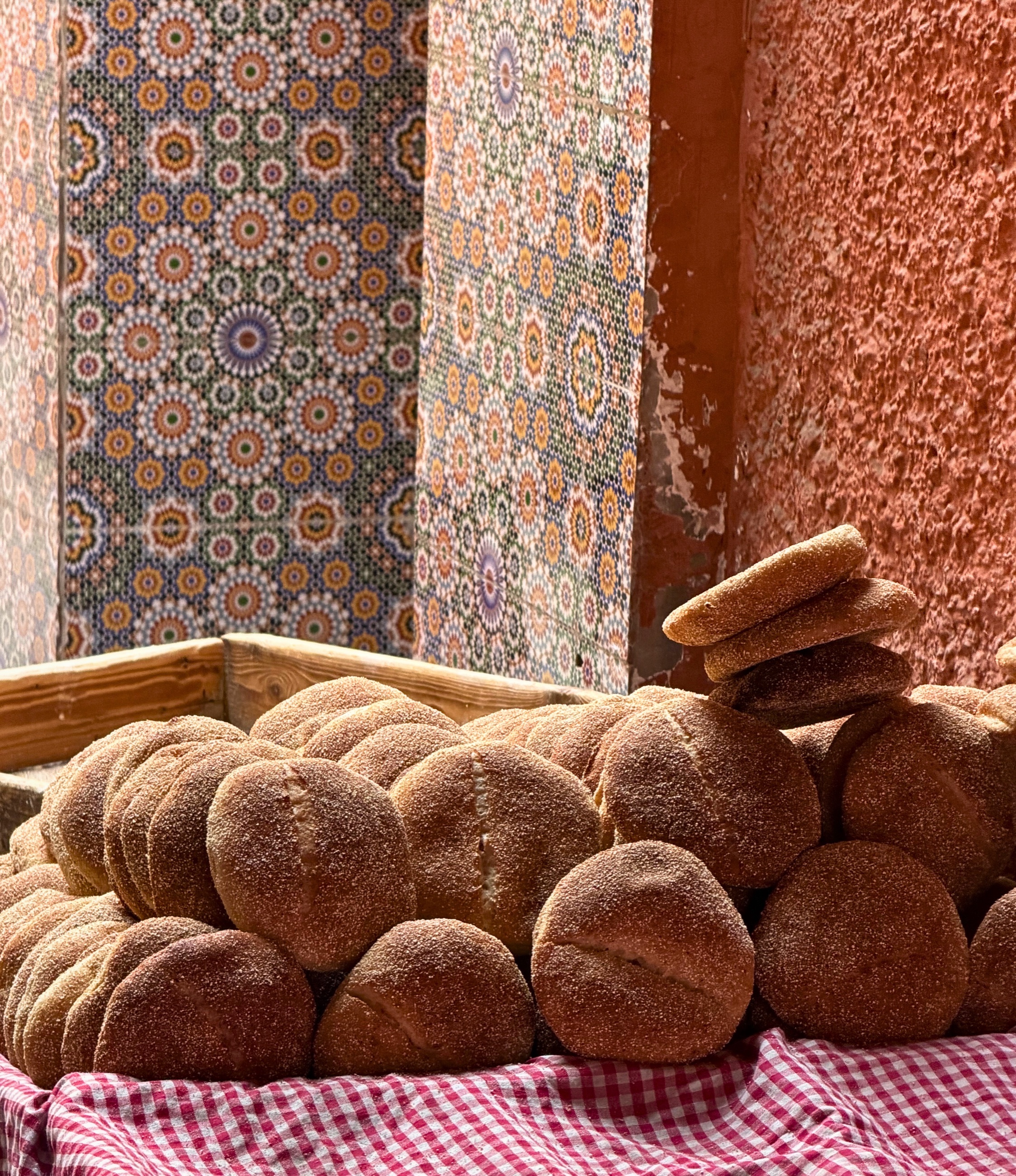 Round loaves of bread stacked on a cart in Marrakesh.