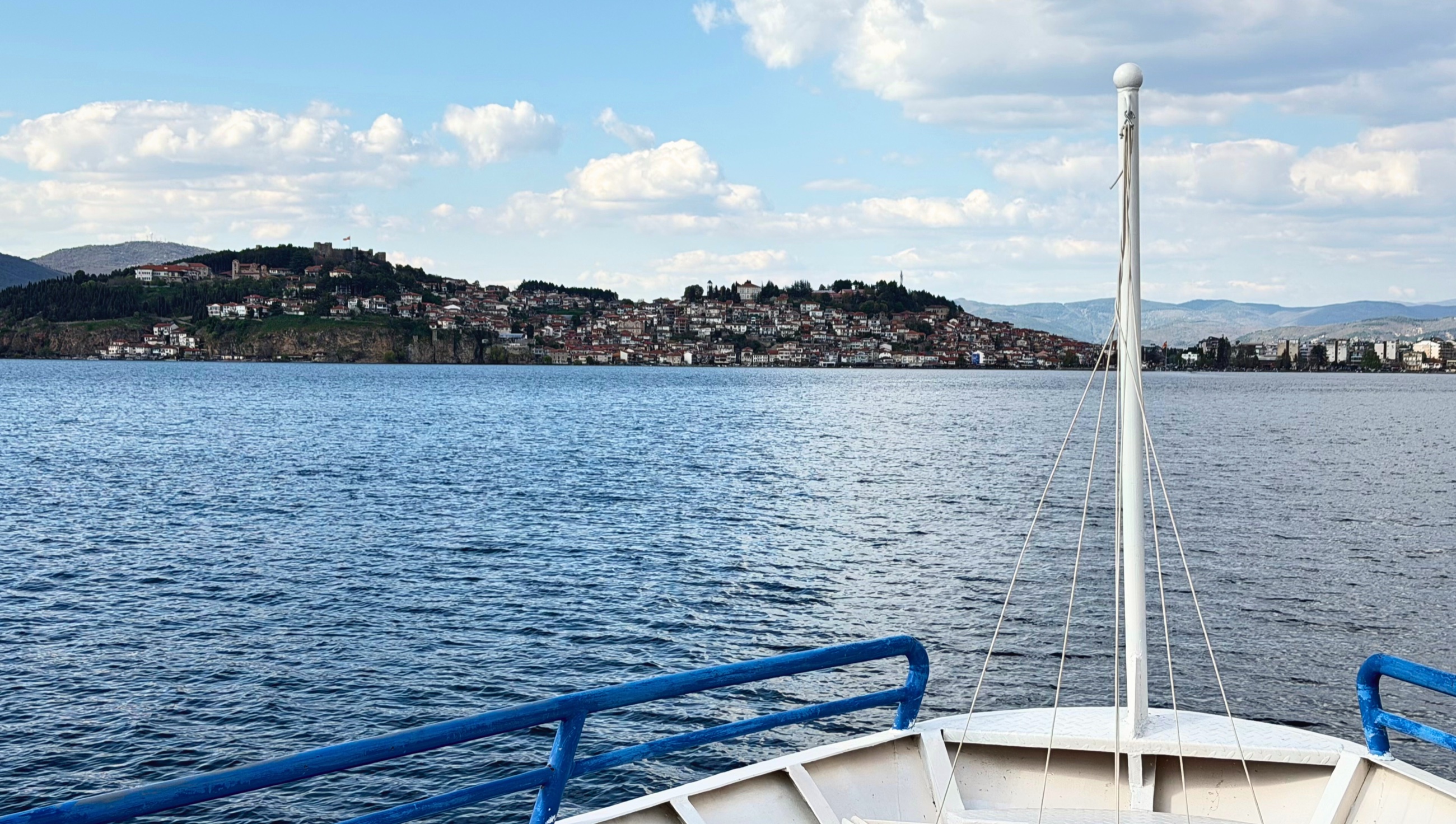 Ohrid seen from a boat on Lake Ohrid with the town, ridgeline, and water in view