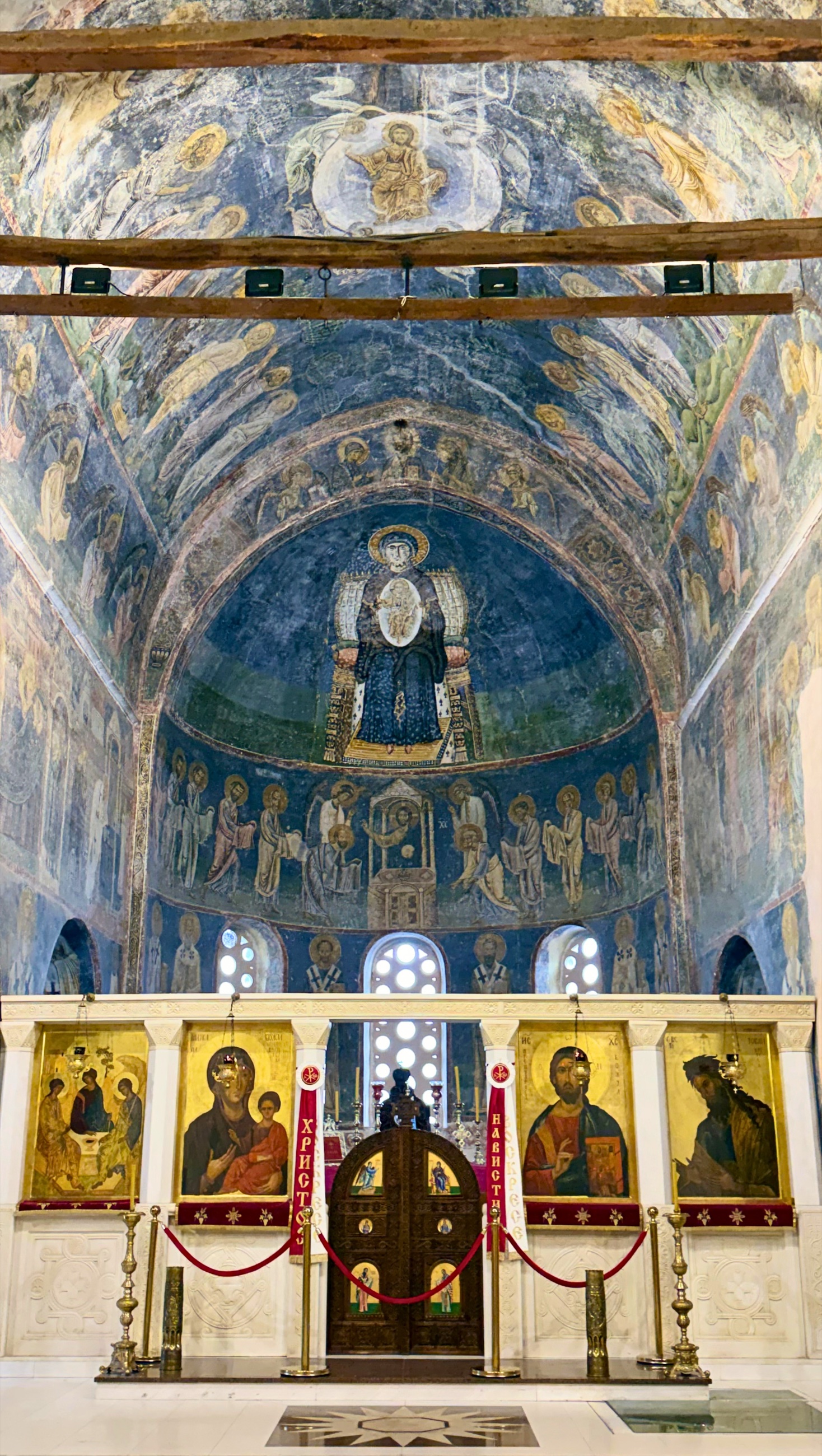 Interior of Saint Sophia church in Ohrid with stone arches and historic frescoes.