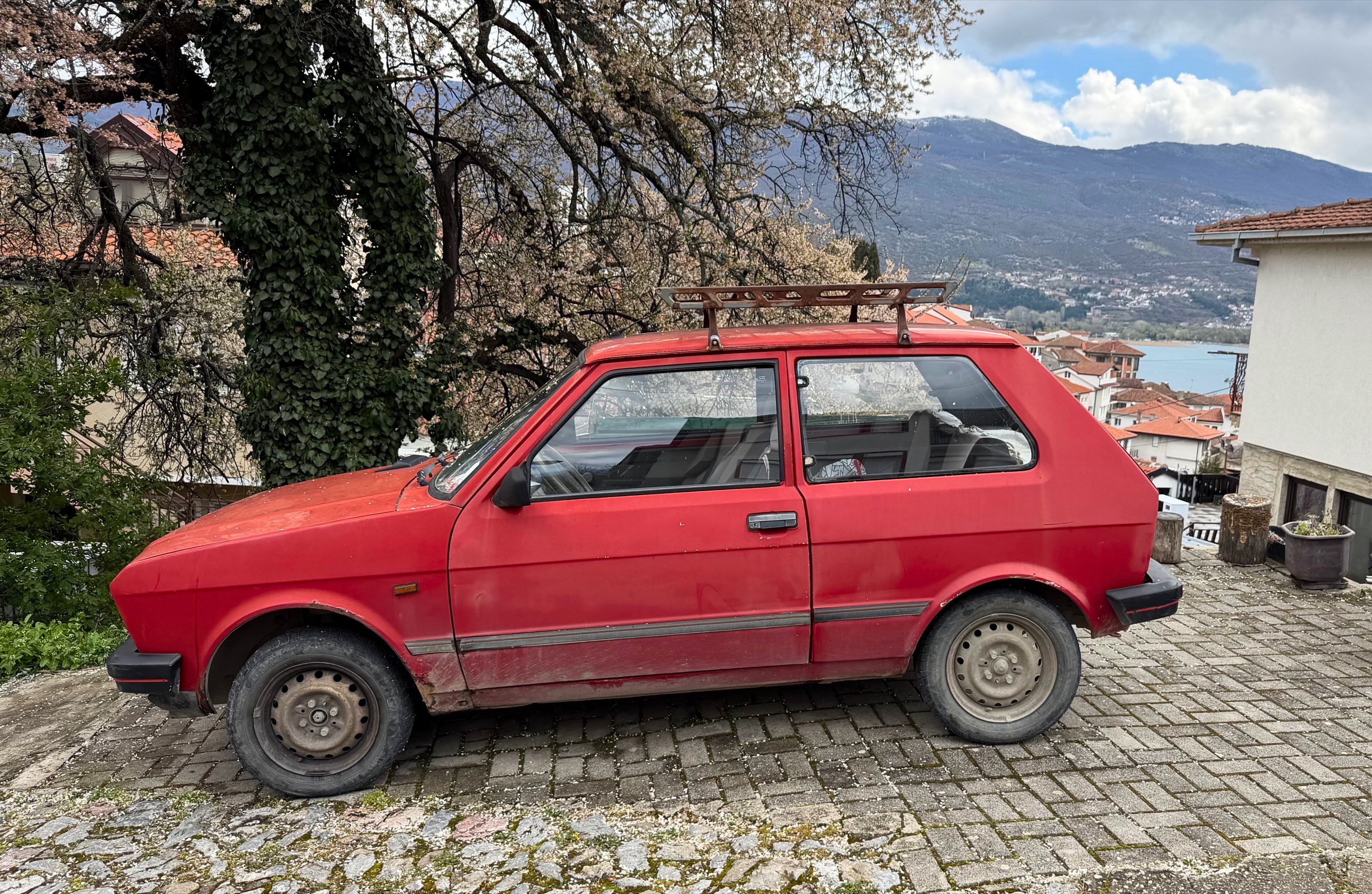A Yugo car parked on a hillside street in Ohrid.
