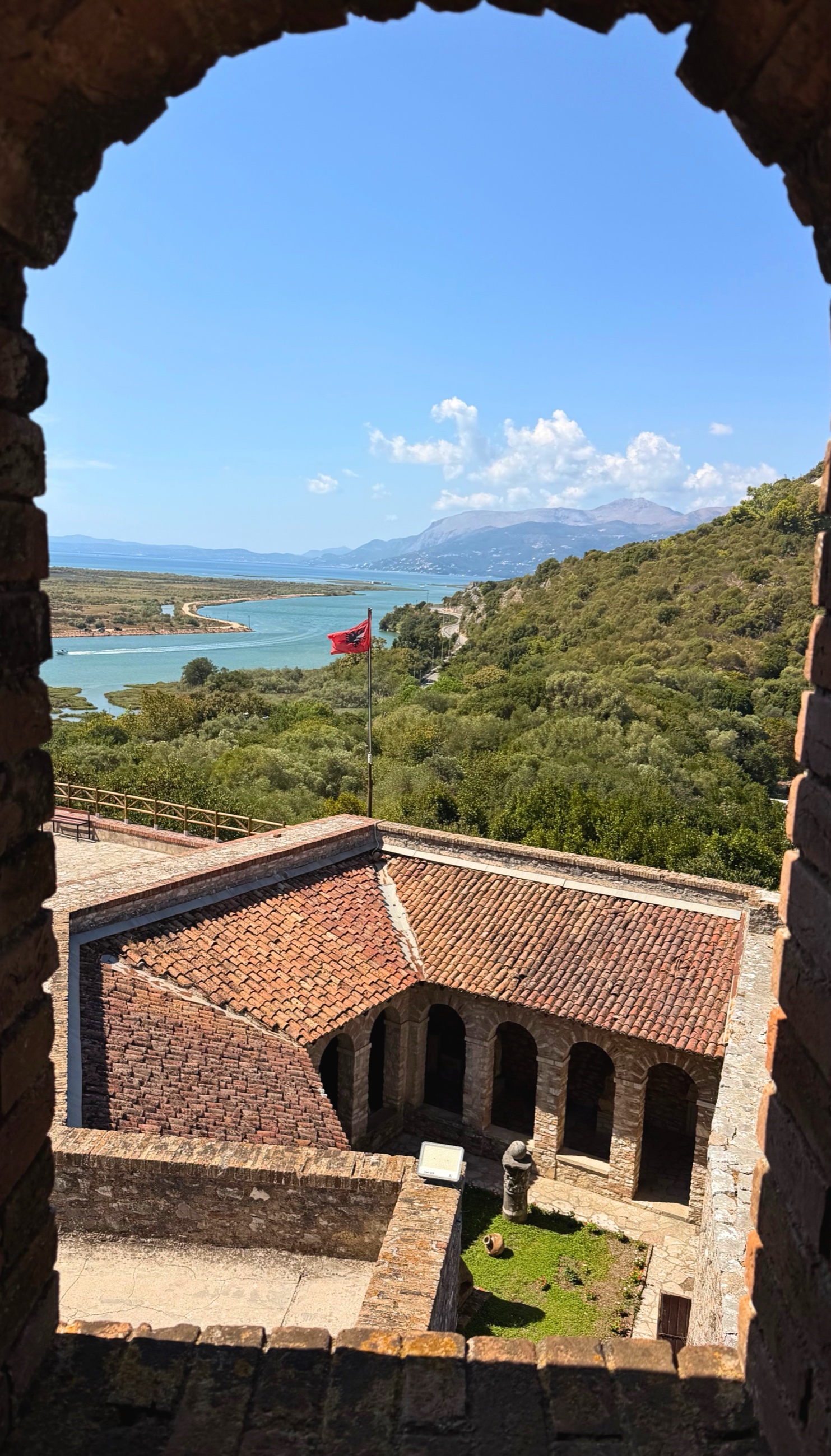 View from the Venetian castle at Butrint across the museum courtyard toward the Vivari Channel and surrounding wetlands.