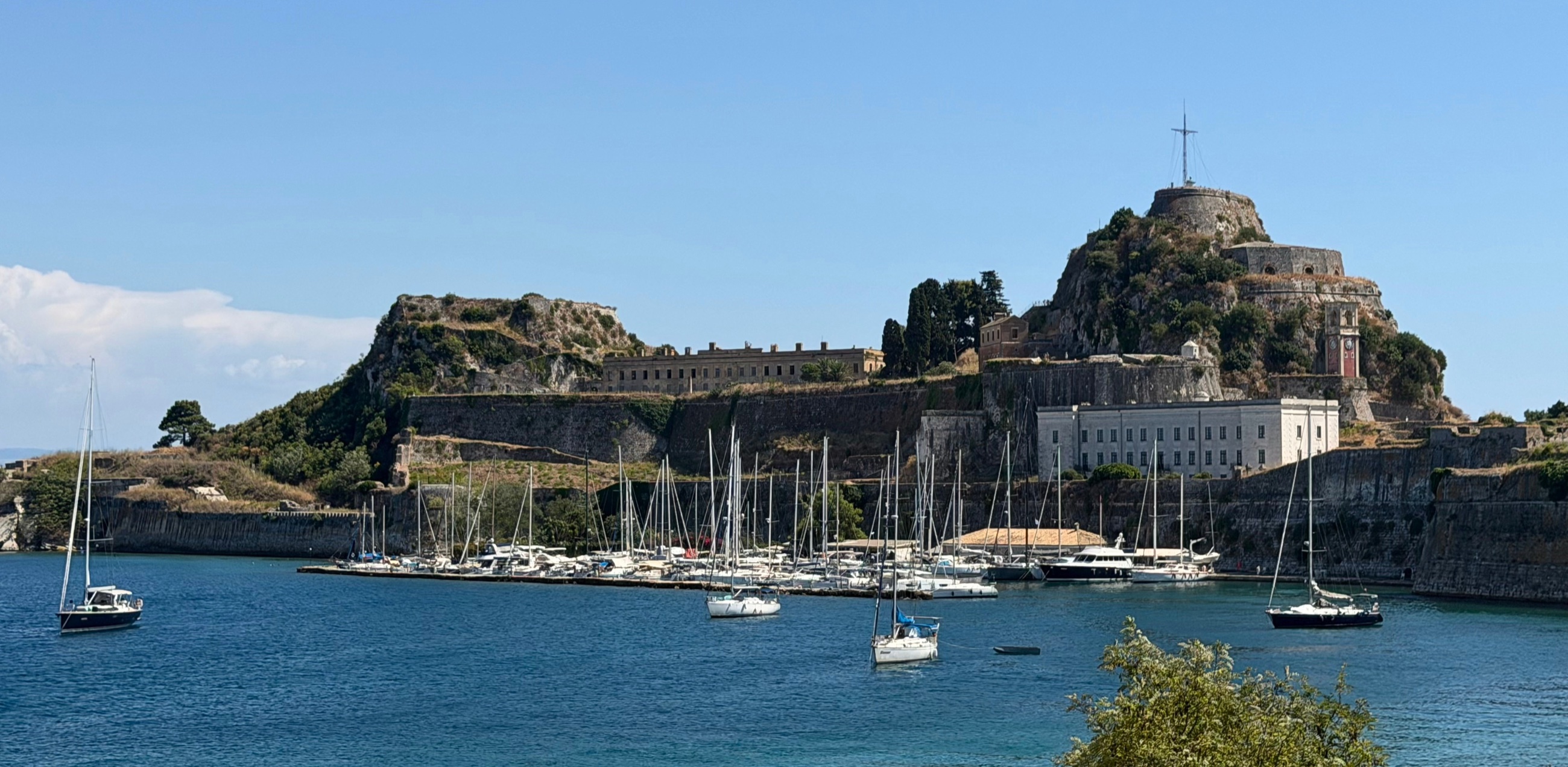 Corfu's Old Fortress rising above the marina and blue water of Corfu Town.