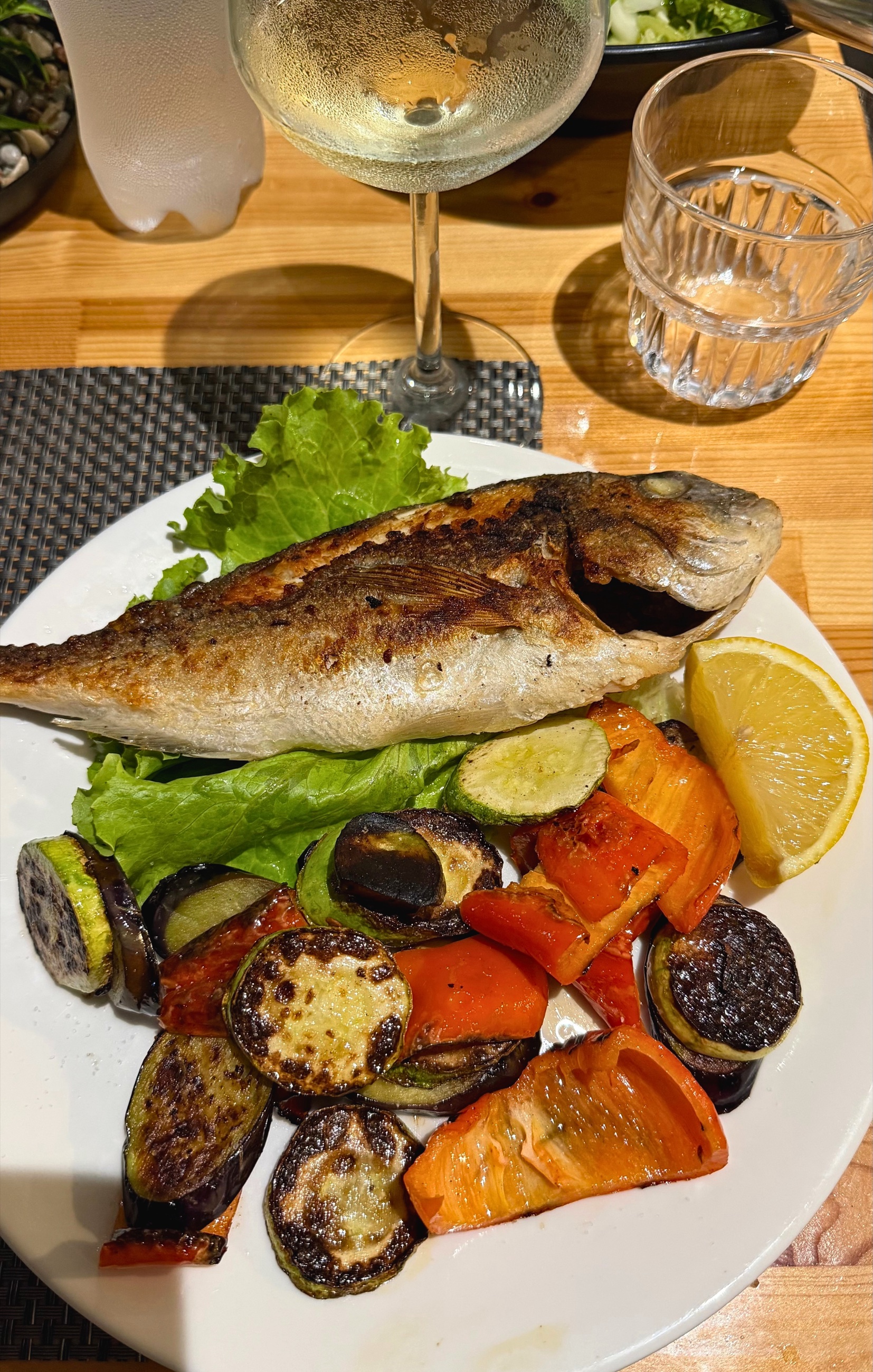 A plate of fresh fish and grilled vegetables at Traditional Table in Sarandë.