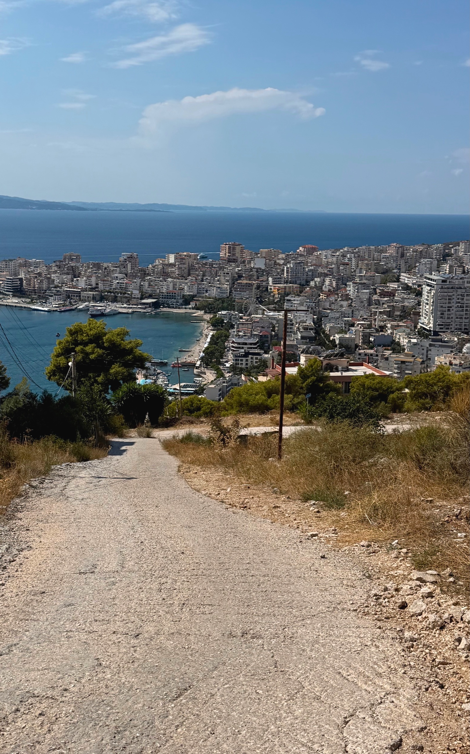 A steep road climbing above Sarandë toward the Monastery of the Forty Saints.