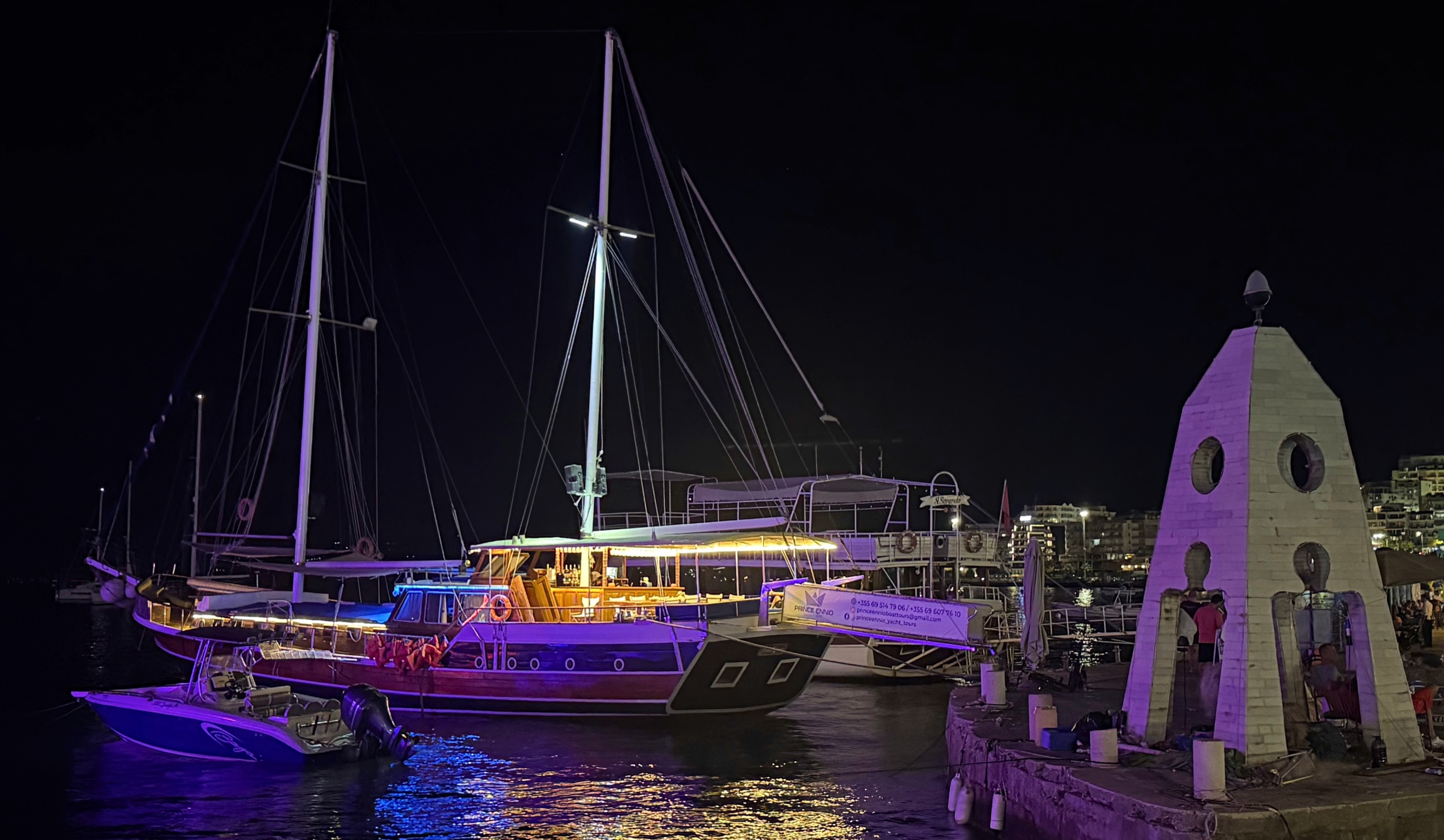 Prince Ennio moored at night in Sarandë harbor.