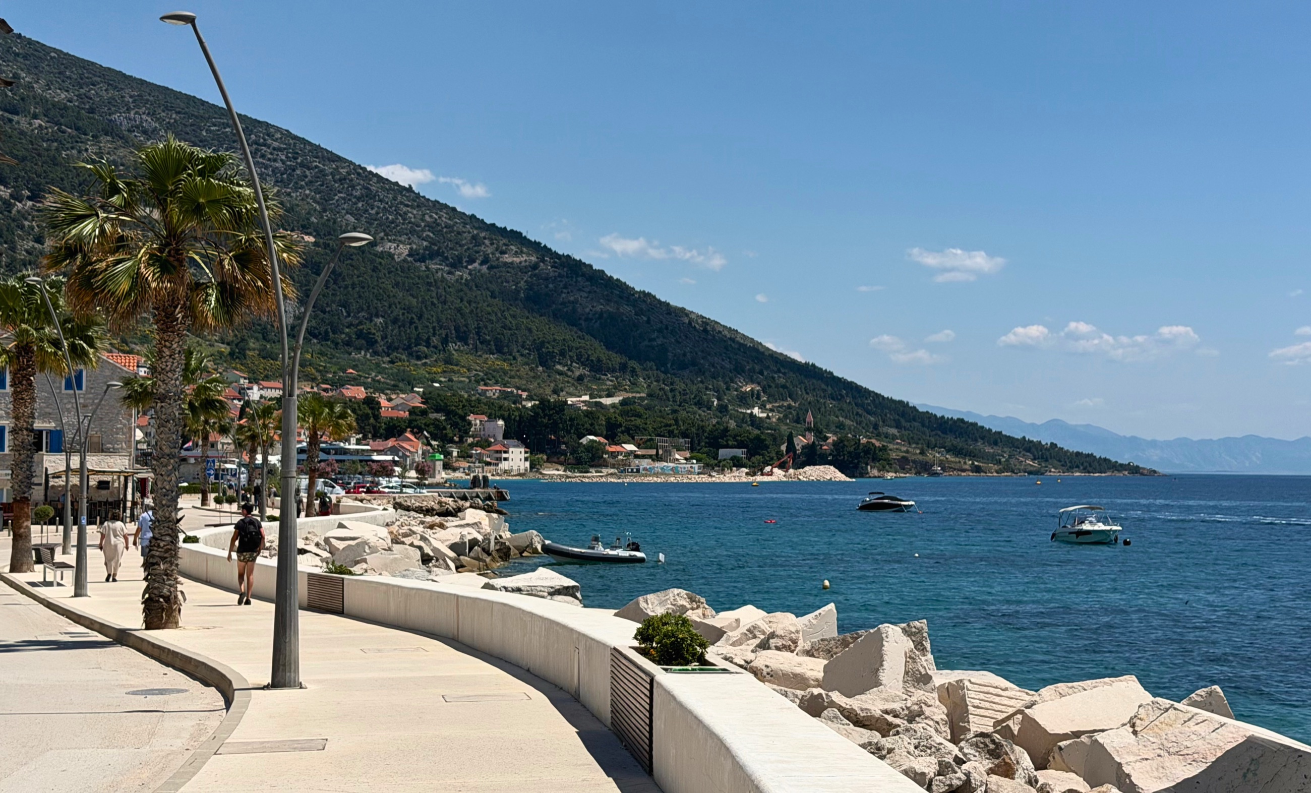 Coastal walking path in Bol on Brač with pine trees and the sea nearby