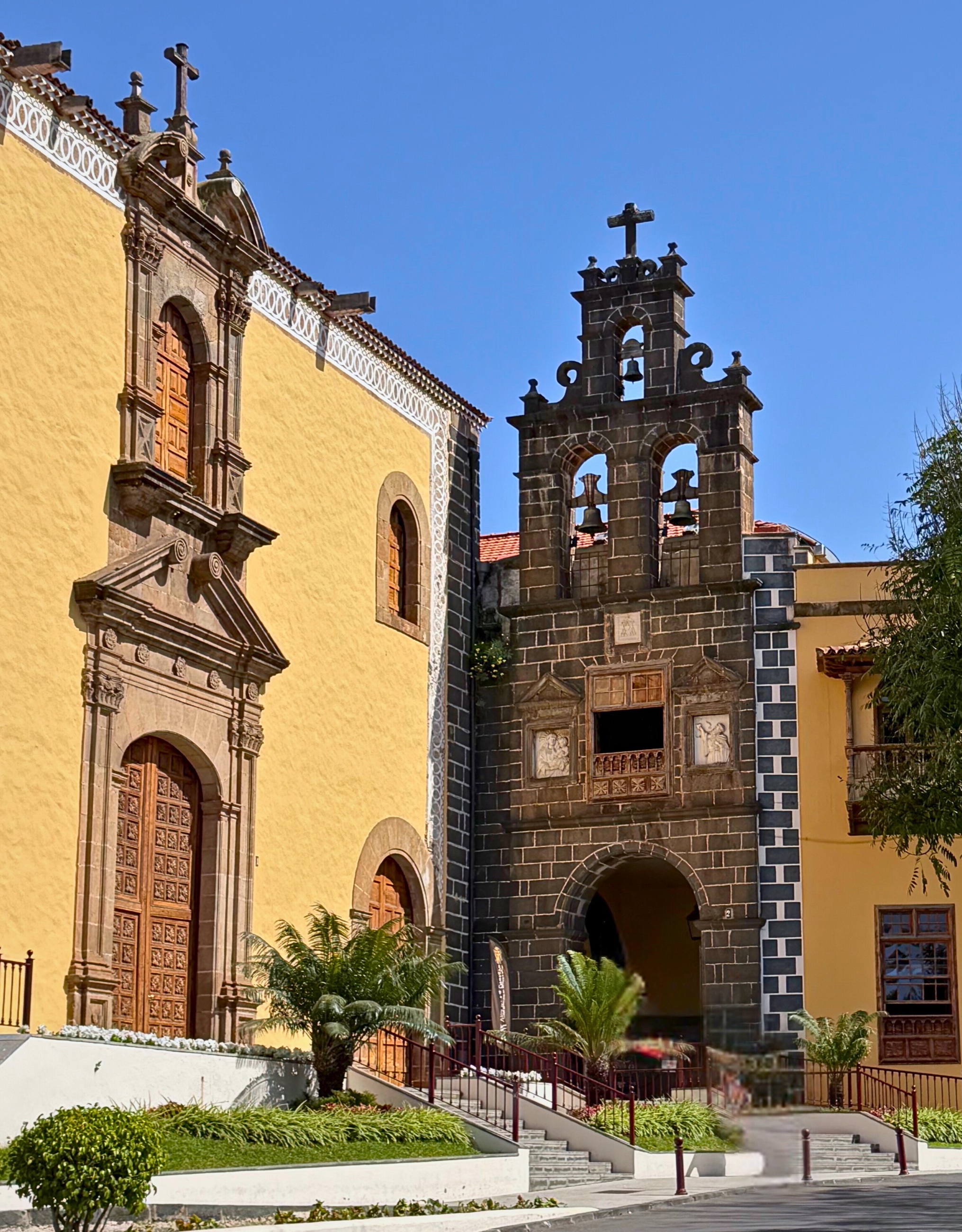 The yellow and dark stone façade of Iglesia de San Agustín in La Orotava.