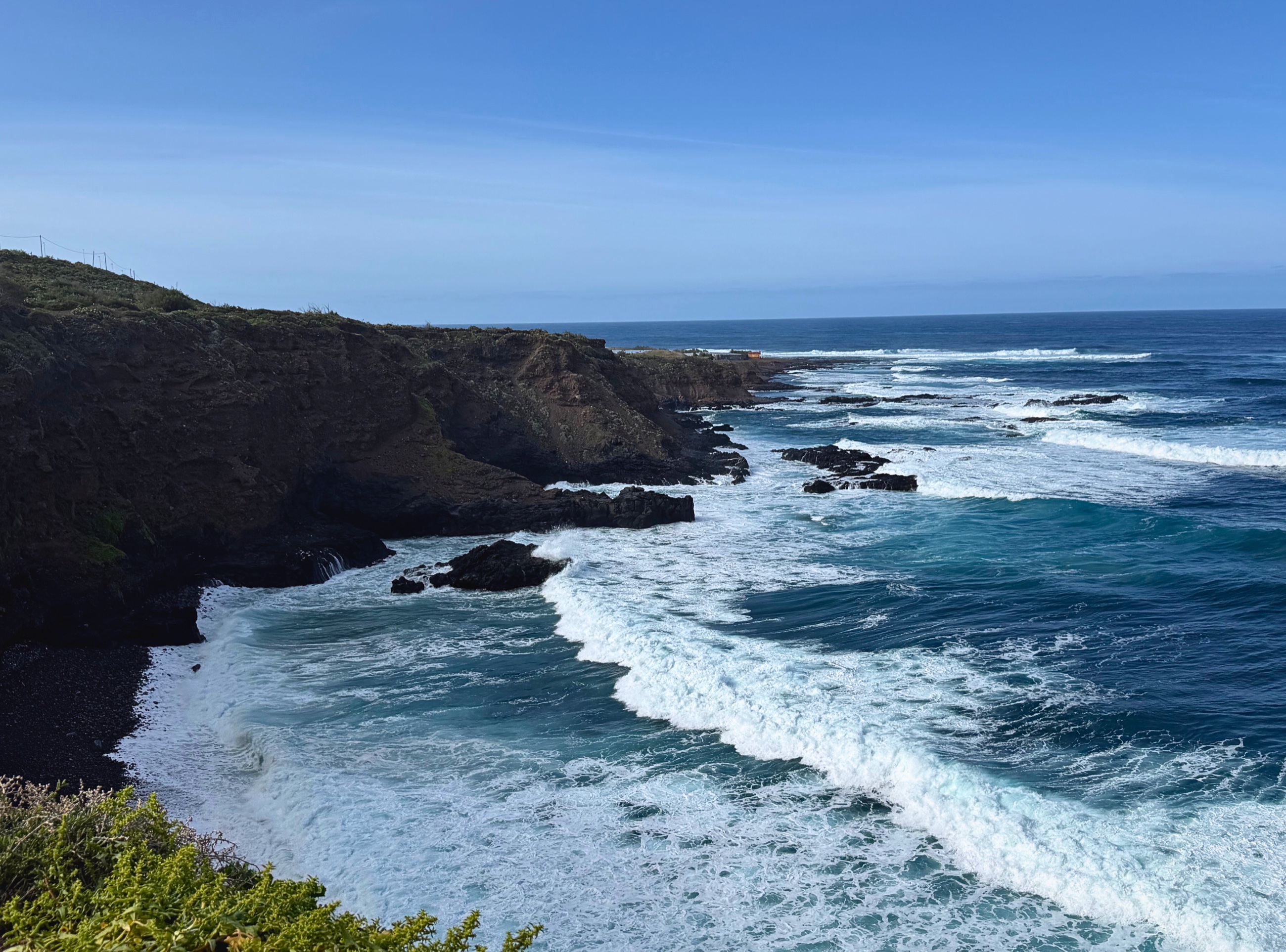 Rugged lava cliffs and Atlantic surf along the Anaga coastline in Tenerife.
