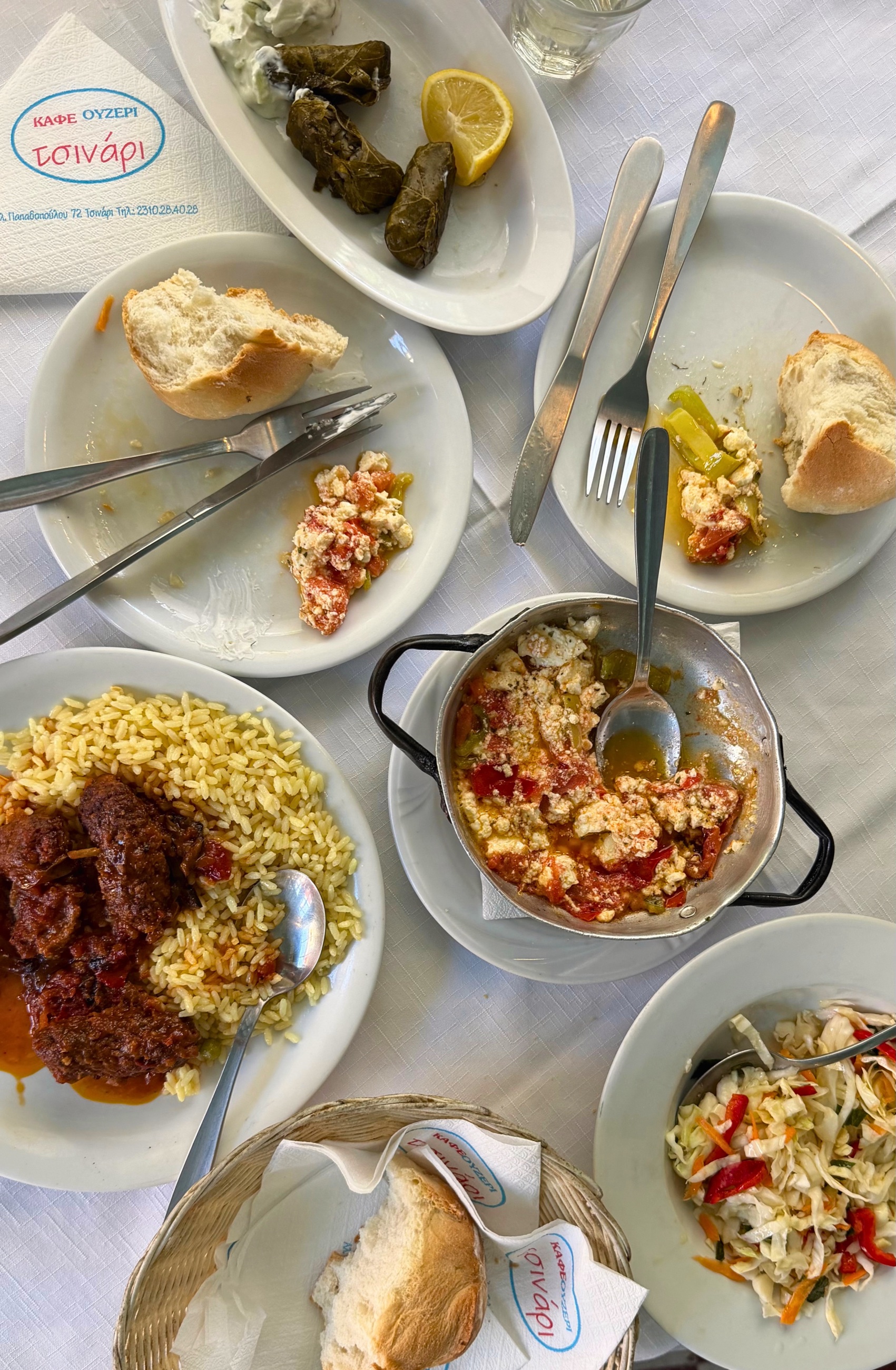 Greek dishes and house wine on the table at Ouzeri Tsinari