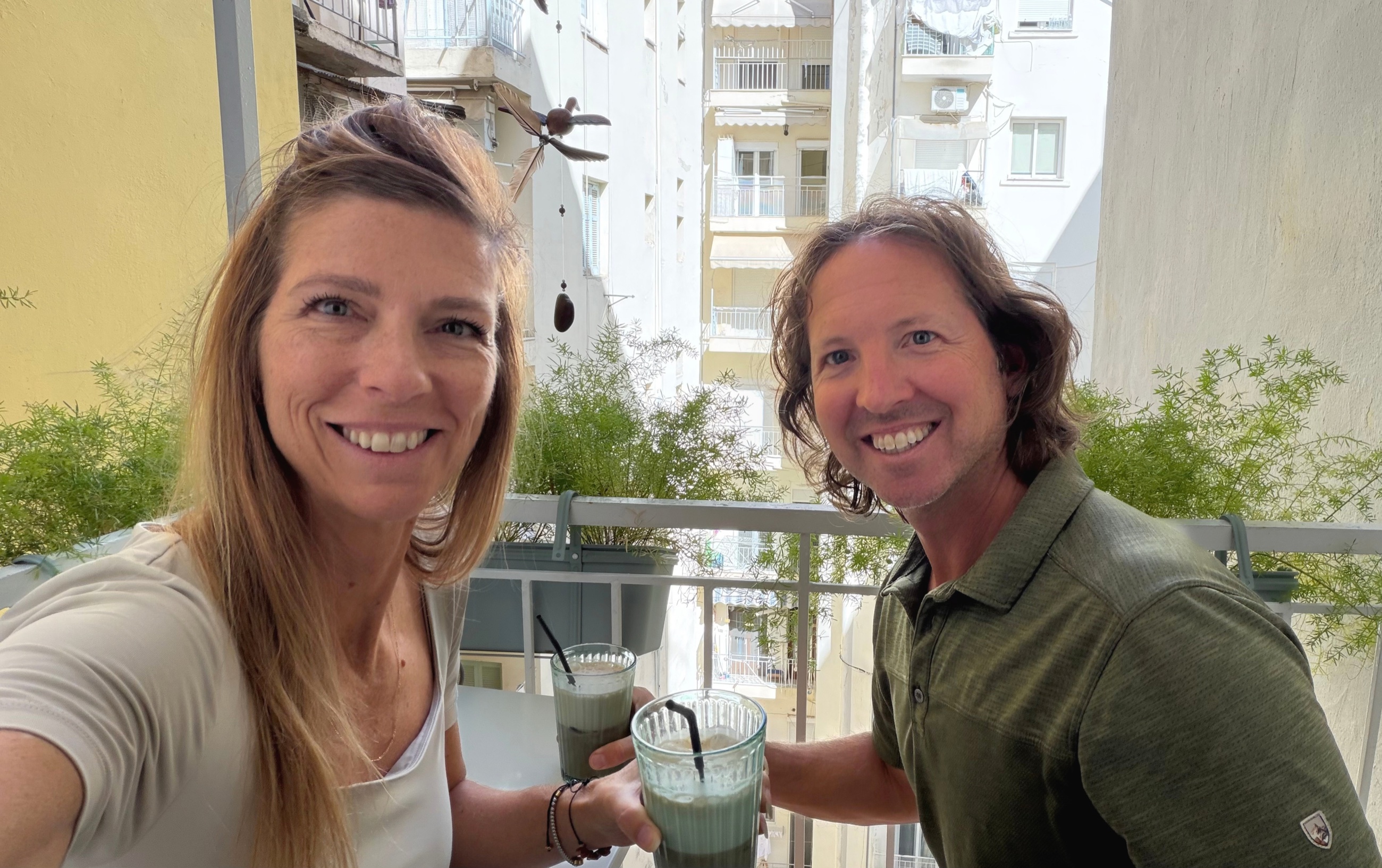 Sam and Stephanie with homemade Freddo cappuccinos on the apartment balcony