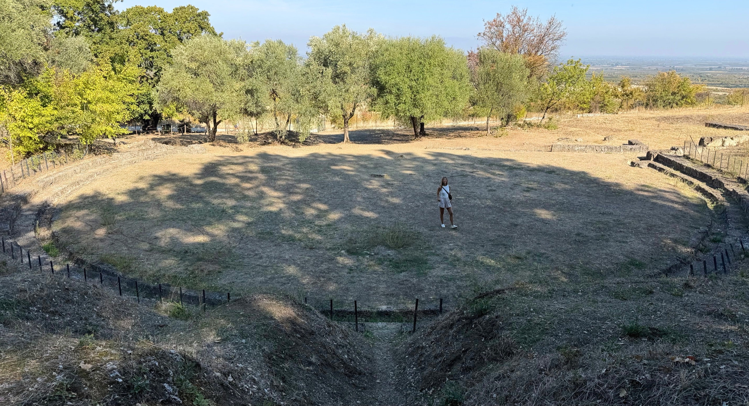Stephanie standing inside the ancient theater at Aigai