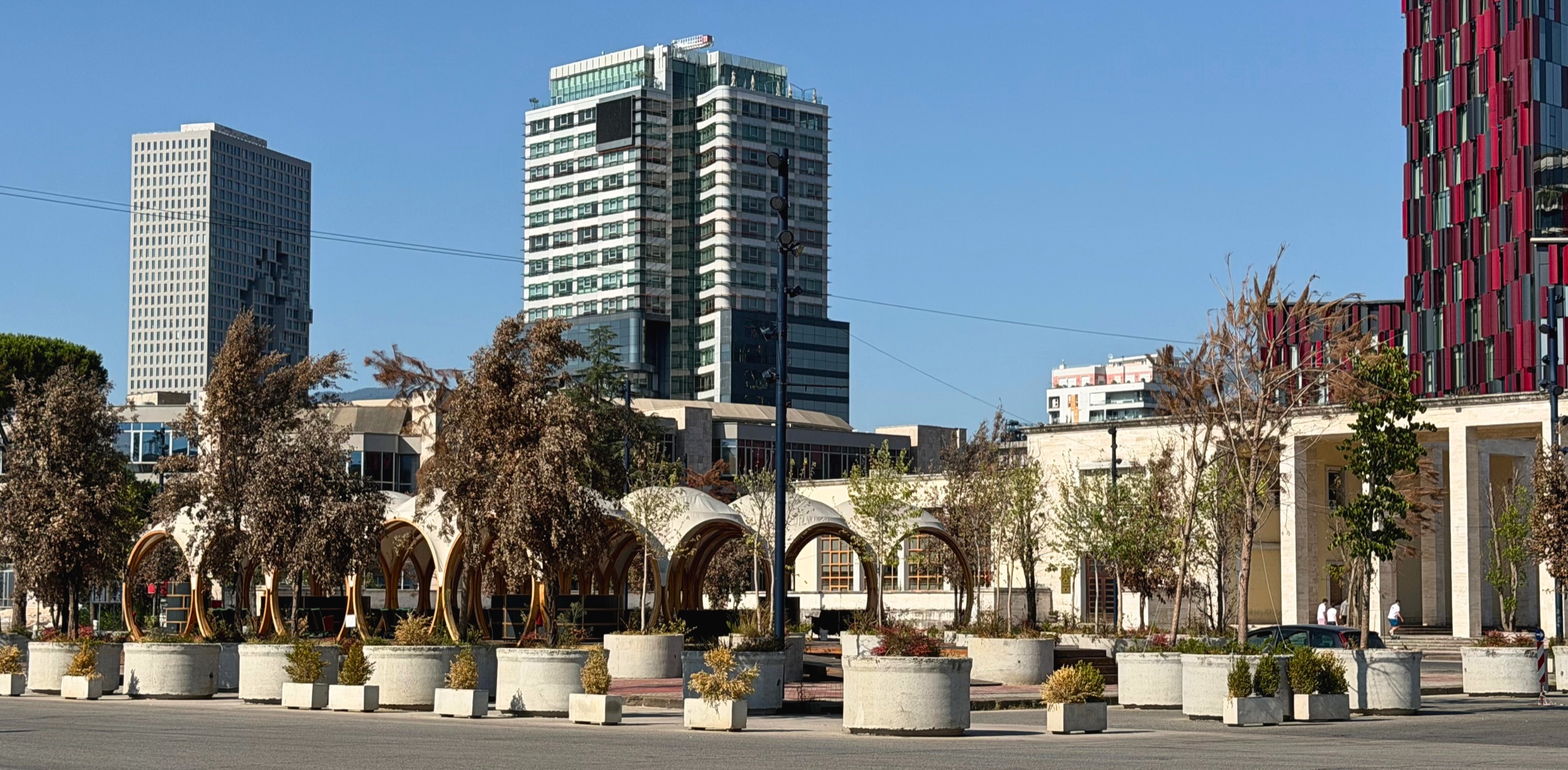 Downtown One rising above central Tirana, its projecting façade forming a pixelated relief inspired by the map of Albania.