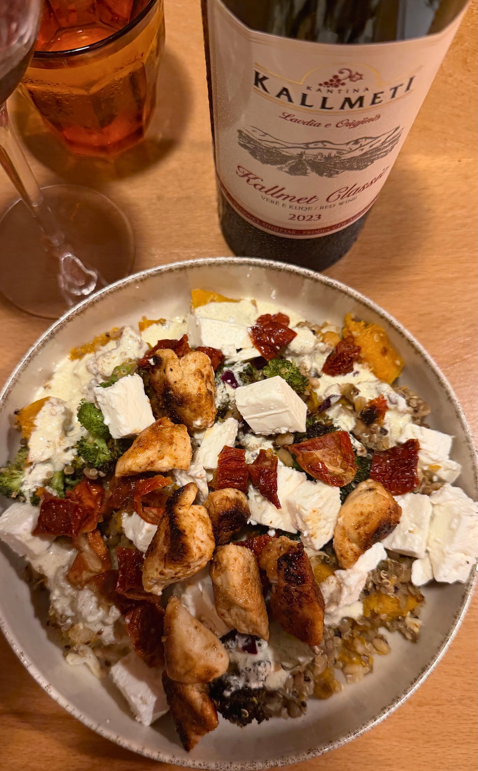 Dinner at home with a bowl made from local ingredients and a bottle of Albanian Kallmeti wine.